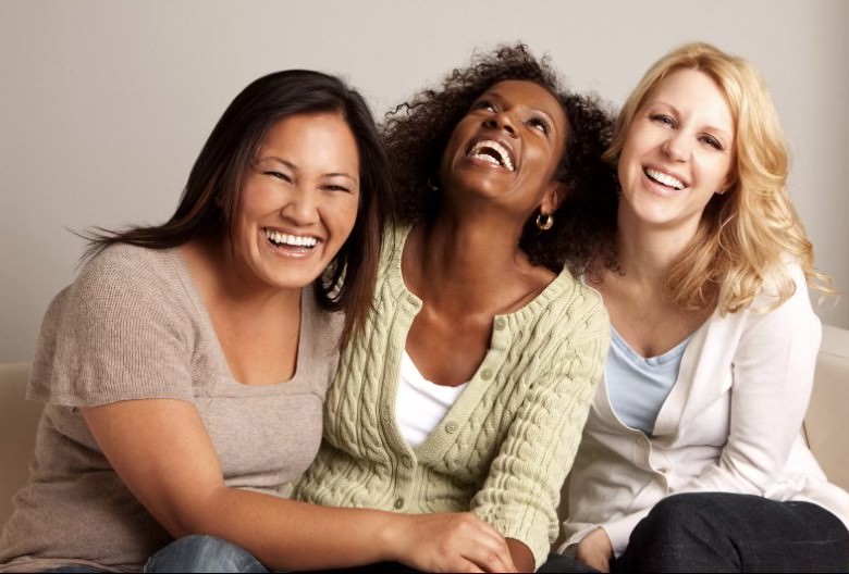 Three women laughing