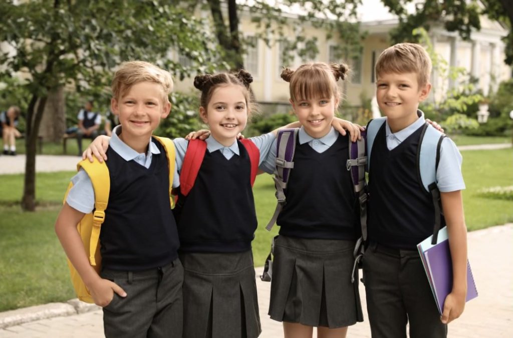Four schoolchildren in their uniforms